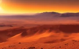Ein sonnenbeschienener Rover Perseverance erkundet im warmen Licht des Marsmorgens inmitten zerklüfteter roter Felsen und feiner Staubwolken eine uralte, feuchte Delta-Landschaft, deren natürliche Details und lebendige Farben die spannenden chemischen Spuren eines möglichen früheren Lebens erahnen lassen.