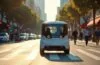 Ein sonnendurchfluteter Straßenzug in San Francisco zeigt ein modernes autonomes Waymo-Robotaxi, das auf einer leicht nassen Kreuzung steht, umgeben von regenfrisch glänzenden Asphaltflächen, während Passanten mit warmem Lächeln respektvoll vorbeigehen und die lebendige urbane Atmosphäre trotz der technologischen Herausforderungen eine hoffnungsvolle Stimmung verbreitet.