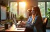 Ein sonnendurchflutetes, modernes Büro mit konzentrierten IT-Experten, die in entspannter Atmosphäre an Bildschirmen arbeiten, umgeben von warmen Holztönen und lebendigem Grün, das die Transformation hin zu vernetzten, cloudbasierten Technologien symbolisiert.